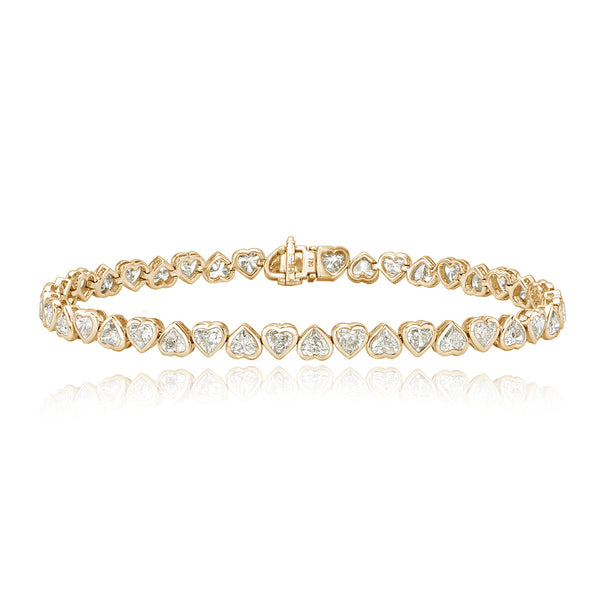 Up and down heart diamond bezel tennis bracelet in 14k gold, playful custom luxury jewelry.