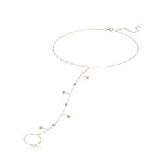 Seven dangling diamond bezel hand chain in 14k gold, a sparkly fine gold jewelry statement.
