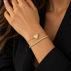 Fluted Outline Pave Heart Bracelet in 14k yellow gold stacked with a diamond tennis bracelet on the wrist