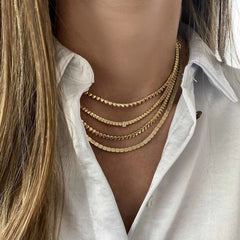 Golden Rectangle and Solitaire Tennis Necklace layered with gold tennis necklaces on model