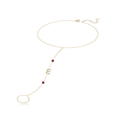 Pavé initial and gemstones hand chain in 14k gold, a luxurious personalized jewelry piece.
