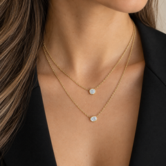 Layered diamond solitaire necklaces in 14k yellow gold worn on model