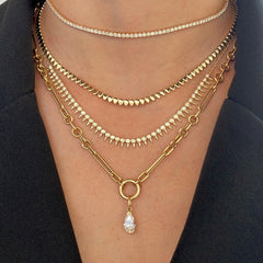 Mixed Paperclip Link Chain with pear diamond charm layered with tennis and gold chains on model