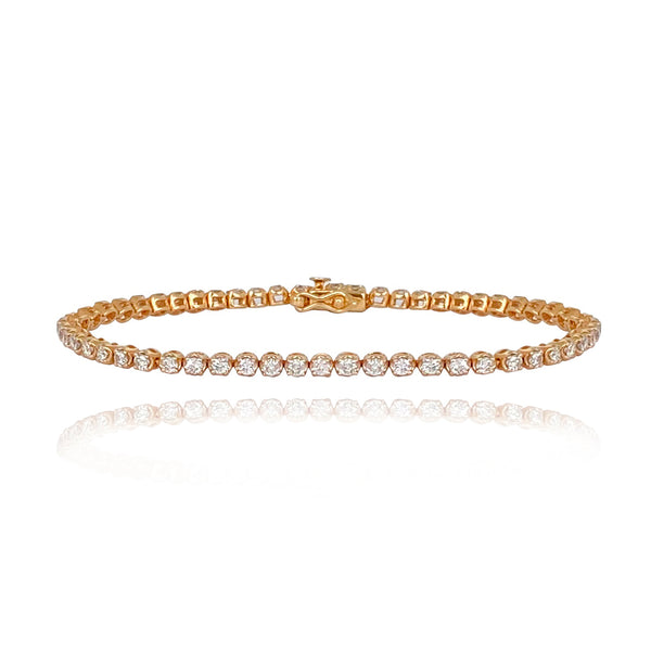 Round setting tennis bracelet in 14k gold, classic fine gold jewelry with luxury diamond accents.