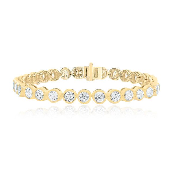 Round bezel tennis bracelet in 14k gold, timeless diamond design for luxury fine jewelry lovers.
