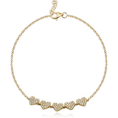 Stunning five-heart pavé bracelet in 14k gold, luxury jewelry design, delicate fine jewelry online.